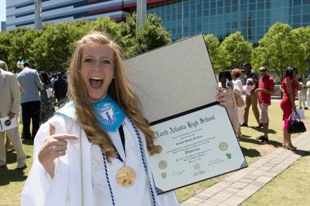 Class valedictorian Kendall De Laria celebrates with her new parchment from her alma mater, North Atlanta. 