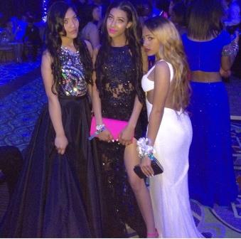 Prom-goers Karla Ochoa-Cuevas, Erica Jackson and Olivia Mathews "glow" in the downtown Omni Hotel.