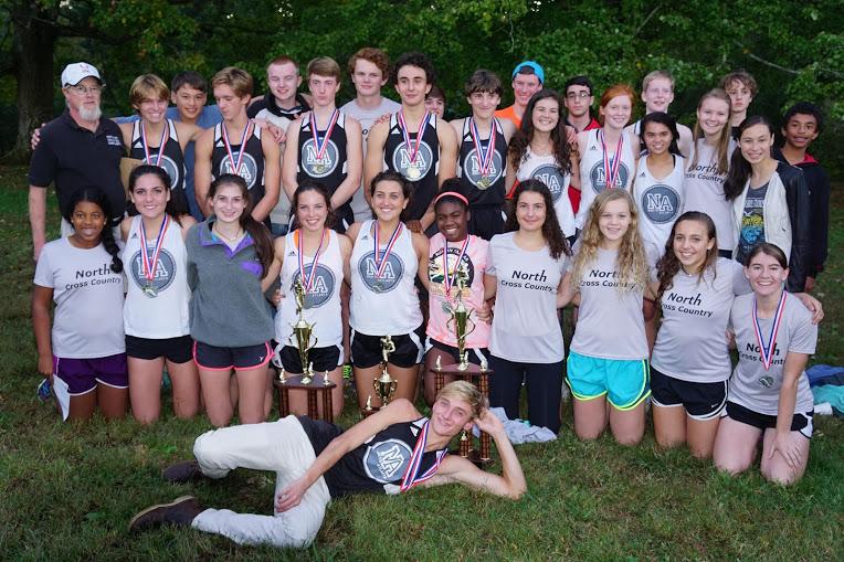 The 2015 Running Warriors pose with their trophies for a team photo.  