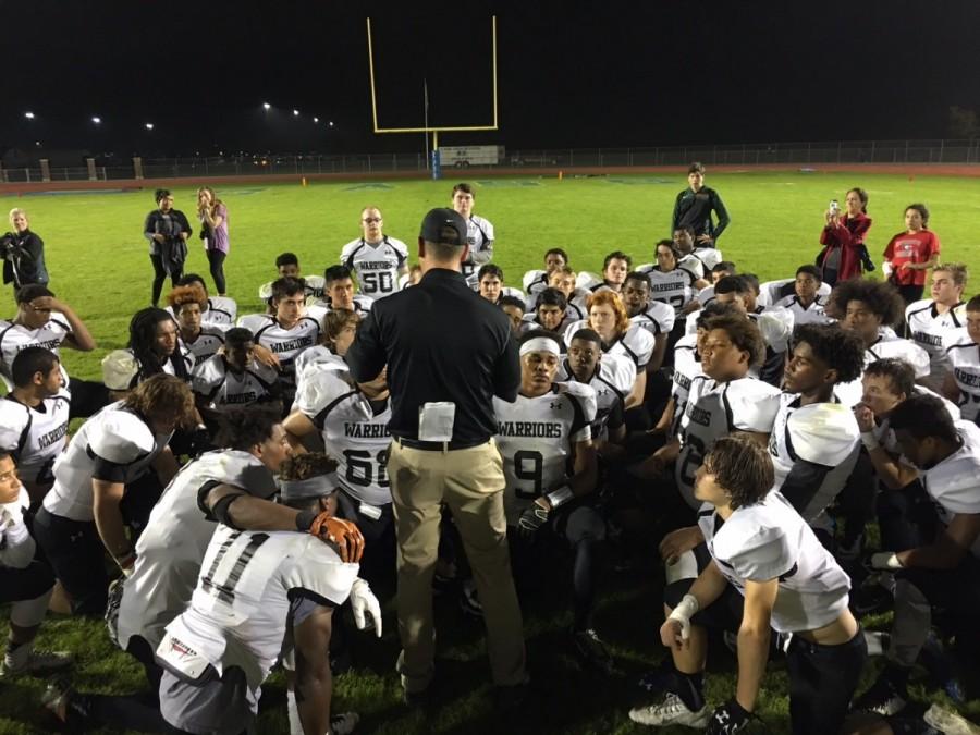 Coach Jeremy Gainer speaks to his team at the conclusion of the Cass game. 