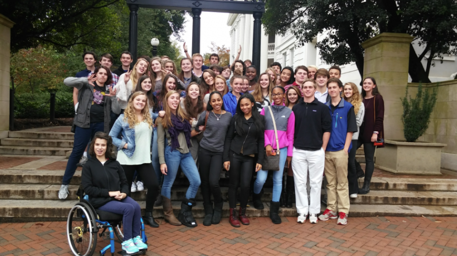 Juniors pose in front of the arch