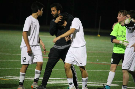 Coach Hemal Patel gives one of his players a celebratory headlock after their winning game against Riverwood. 