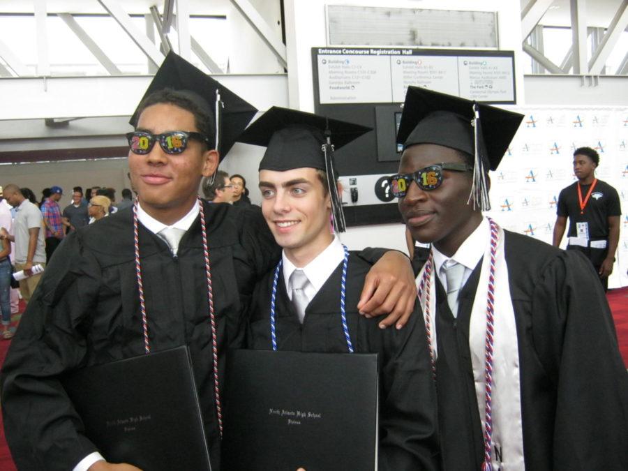Class of 2016 graduates Niko Stines, Kyle Anderson and Lancina Djibo revel in the moment after their May 26 graduation ceremony in the Georgia World Congress Center. 