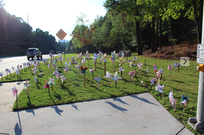 Northside+Parkway+commuters+catch+a+glimpse+at+the+array+of+colorful+pinwheels+scattered+across+North+Atlantas+front+lawn.+