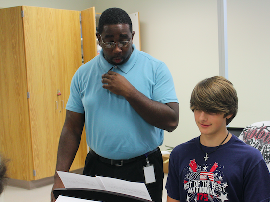 Piano teacher, Adrian Ford, assists a student during instructional time. 