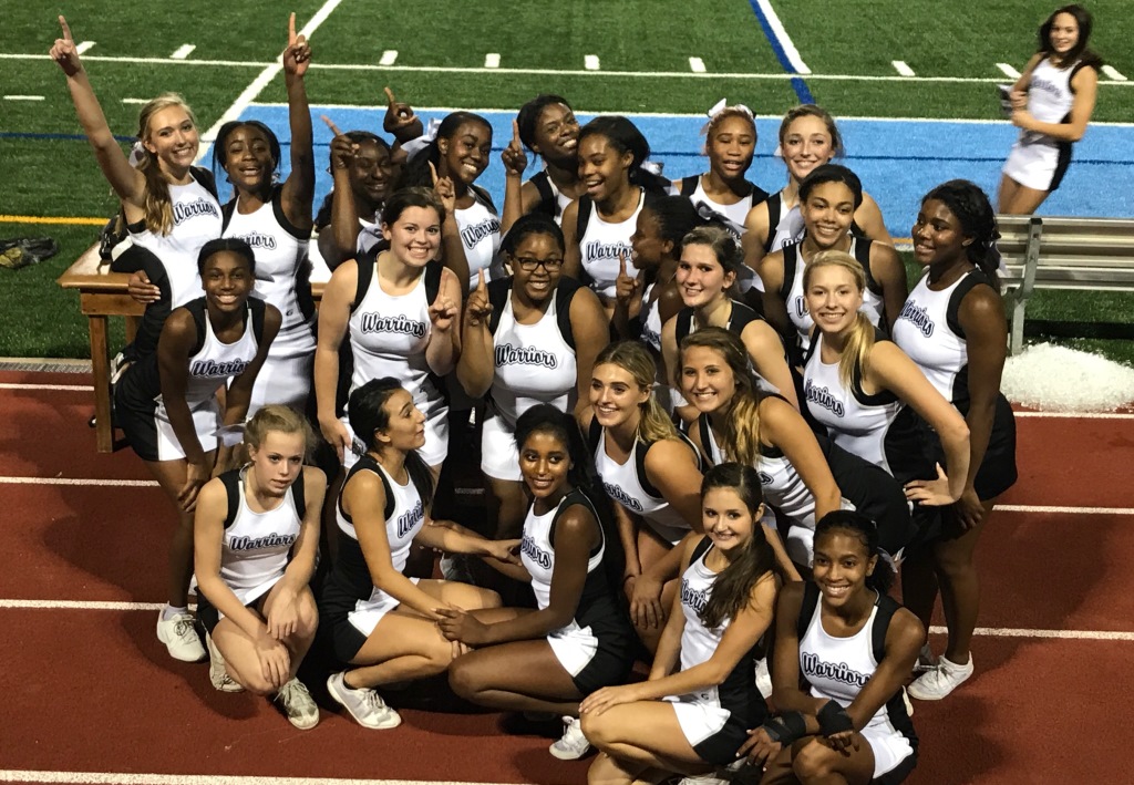 North Atlanta varsity football cheerleaders pose together before unleashing their power. The squad has benefitted from the coaching leadership of literature teacher Jennifer Page. 
