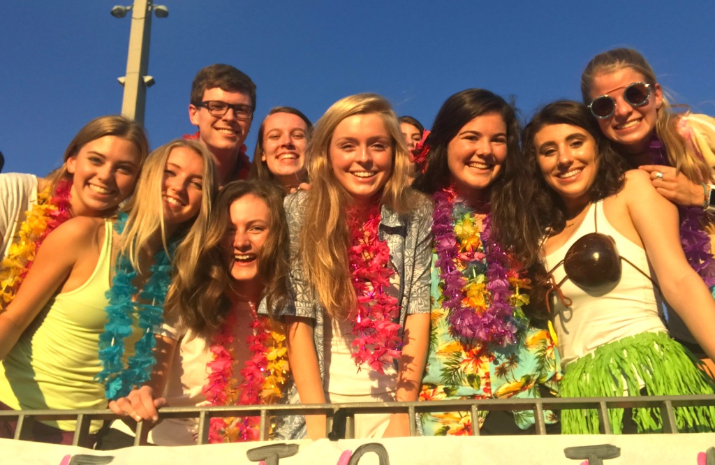 North Atlanta seniors are amped up in the on-fire student section during the Aug. 18 Warrior victory over arch-rival Grady. The Warrzone theme for the game was a Hawaiian luau. 
