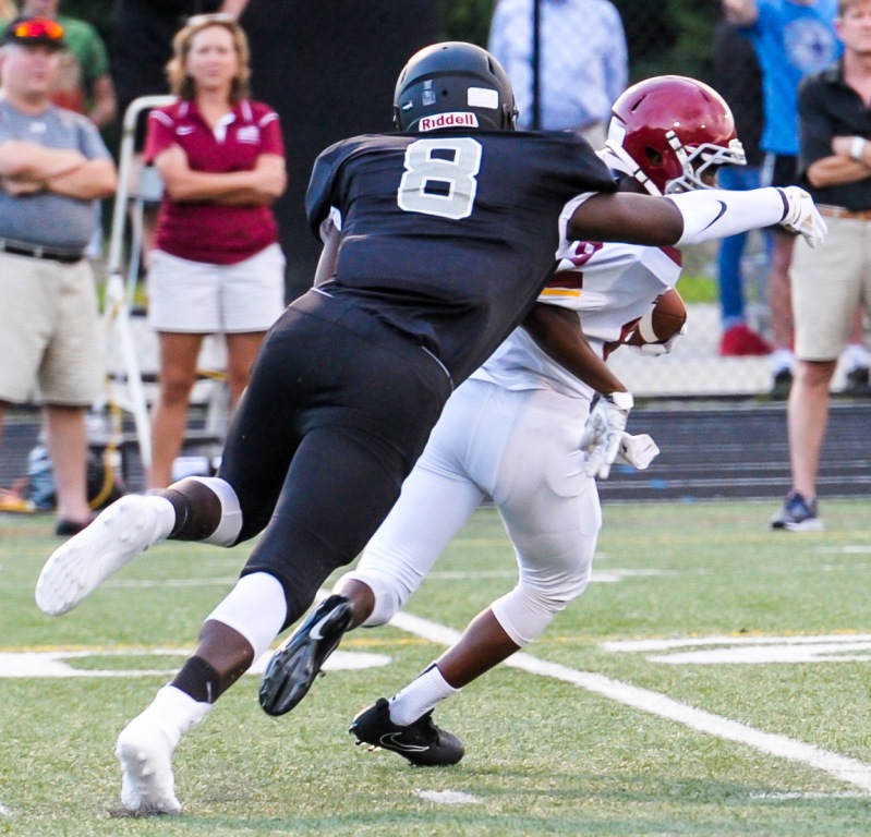 Warrior defensive end Caleb Washington chases down the opposition.  
