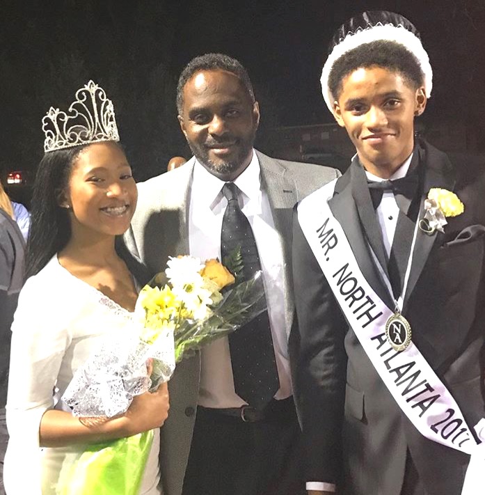 Mr. and Mrs. North Atlanta Kaylan Johnson and Bakari Smith share a happy moment with North Atlanta Principal Curtis Douglass.
