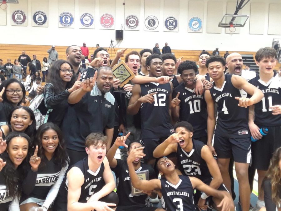 The North Atlanta basketball and cheerleading team strikes a pose together, in show of a unified region tournament win.