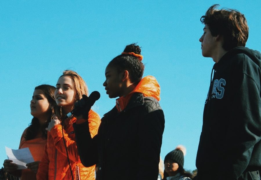 During a March 14 walkout event at North Atlanta High School, senior Adenike Makinde read a list of the names of the 17 victims who were killed during the Feb. 14 school shooting in Parkland, Florida. Also shown are Roya Register, Jessica Milburn, and SGA President Chandler Smith