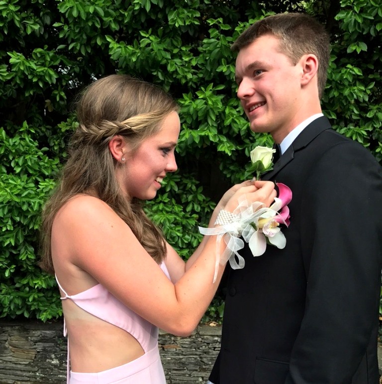 Big+Night%3A+Margaret+Gustafson+pins+a+boutonniere+on+her+date+Caleb+Burns.+The+two+were+juniors+when+this+photo+was+taken.+