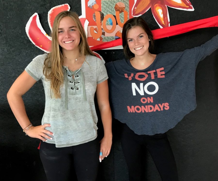 Dedicated Dubs: Junior Chloe Van Nort and senior Addie Derrick, leaders in the North Atlanta Spirit Club, are painting the town black and silver and promoting school spirit in any way they can.  
