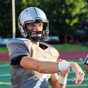 Dub Duds: Junior quarterback Wiley Hartley rocking Warriors’ new unis on the sideline during 20-7 victory over Grady. 
