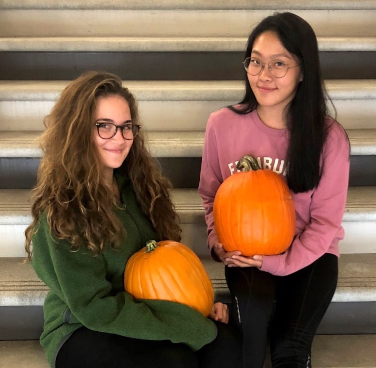 A New Leaf: Juniors Charlie Olson and Grace Choi embrace fall by embracing their favorite member of the gourd family, the pumpkin.