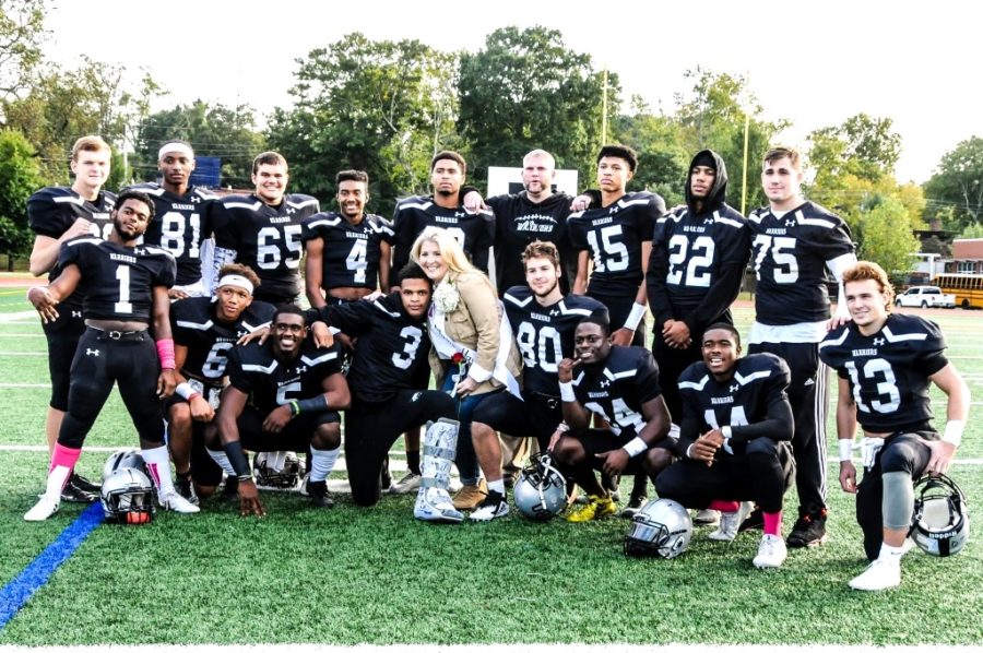 Senior Moment: Warrior seniors have built a strong foundation for future success.  Gathered during their senior night win against Dunwoody on Oct. 20 were (front row): Christian Tanks, Jahlani Hall, Justin Sanders, Iann Hicks, team mom Allison Hayes, Ford Hayes, Jaden Yankey, Amir Simpson and Ben Sumlin; (Back row): Nathan Kitts, Justice Arnold, Jack Sullivan, Antonio Prioleau, Josh Johnson, head coach Sean O’Sullivan, Bryce Williams, Andrew Robinson and Enzo Vasallo.  
