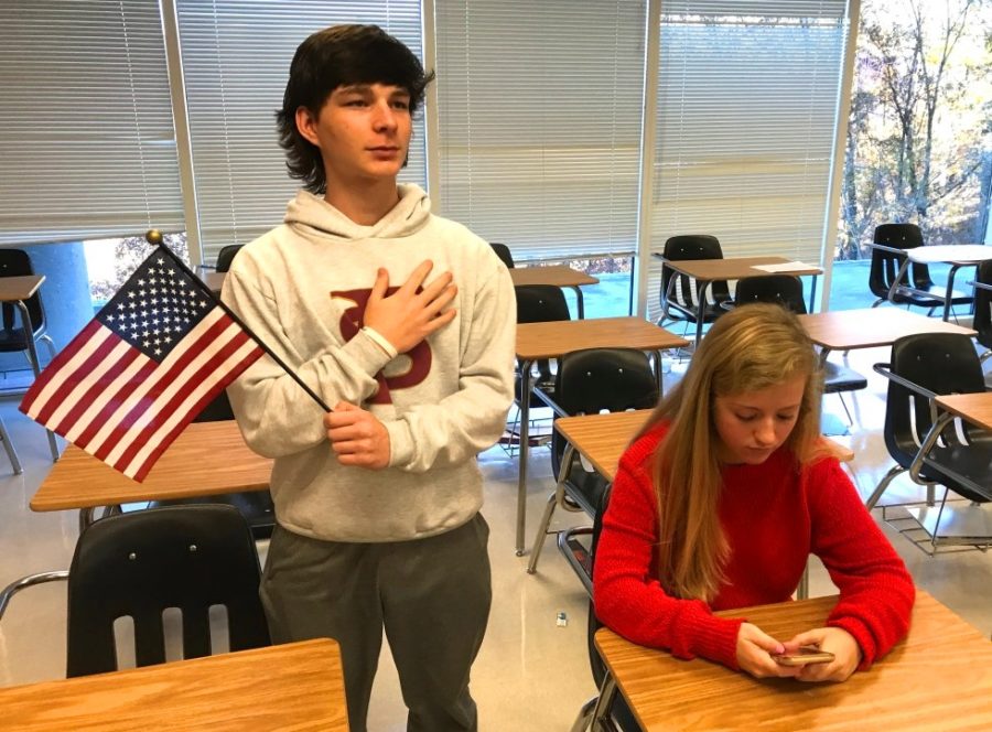 To Sit or Stand, That Is the Question: Sophomores Mark O’Meara and Graham Barnett choose to either sit or stand for the morning Pledge of Allegiance. 