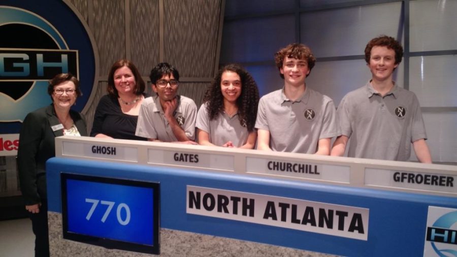 Brain Power: Seniors Quint Gfroerer, Jake Churchill, Ishaan Ghosh and Devon Gates stand together after their 2018 championship win on the High Q academic game show as a part of the Academic Quiz Bowl. They are shown here with APS board member Cynthia Briscoe Brown (far left) and Nancy Hunter, Quiz Bowl team faculty adviser. 