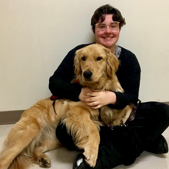 Fuzzy and On the Job: Sophomore Stella Thrasher gets aid from Lager, a Golden Retriever service dog on the job that regulates her blood sugar. 