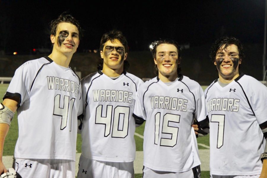 Stick Together: Junior James Brewer, junior Tommy Fialkowski, senior Mason Lassiter, and senior Devon Lassiter celebrate their most recent lacrosse game in their unique secret language.