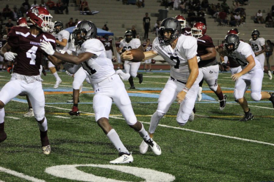 Caretaker: Wide receiver, Trey Harris, leads the way with a strong block for quarterback, Wiley Hartley, on a first down run.