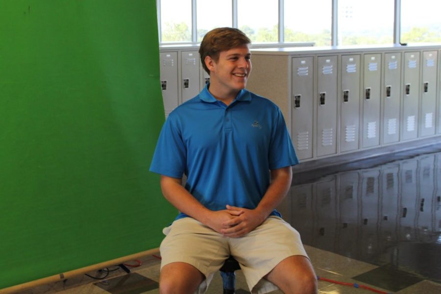 Say Cheese: Junior Matt Love smiles big as he gets his picture taken