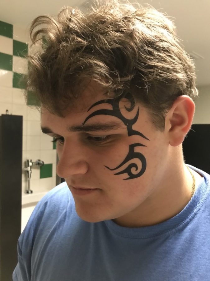 Photo Caption: Diesel Tyson: Senior Davis Bell shows off a particularly embarrassing punishment connected to his school-based fantasy football league. Other punishments include: eating vanilla pudding out of a mayonnaise jar and carrying around a rag during school and cleaning the other players’ shoes.