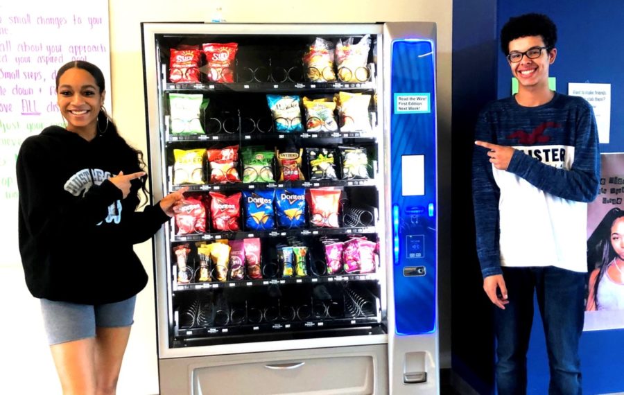 Super Snacks: Seniors Ayla Amomah and Mahki Lloyd admire the new vending machines all over the North Atlanta halls. 