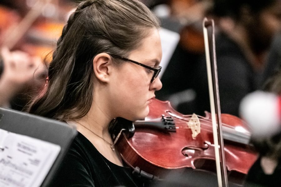 String Thing: Sophomore violinist Sydney Heaton makes music along with her colleagues as a member of the North Atlanta Orchestra. Cady Studios  