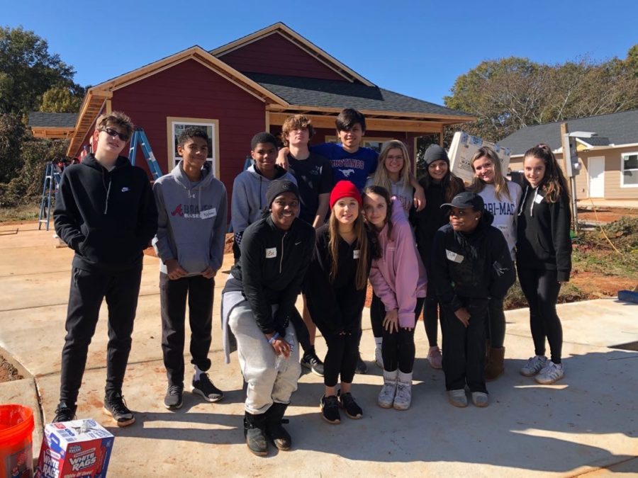 Caring Students: Members of Habitat for Humanity smile as they help the community