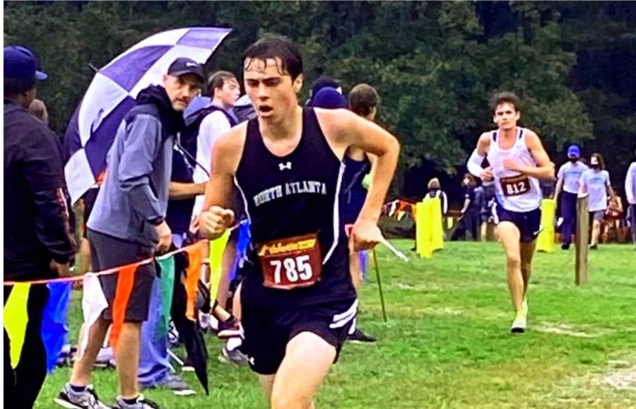 During the Atlanta Classic in Western Douglas County on Oct. 9, senior Andrew Churchill pushes through the first lap of a rainy and muddy meet.
