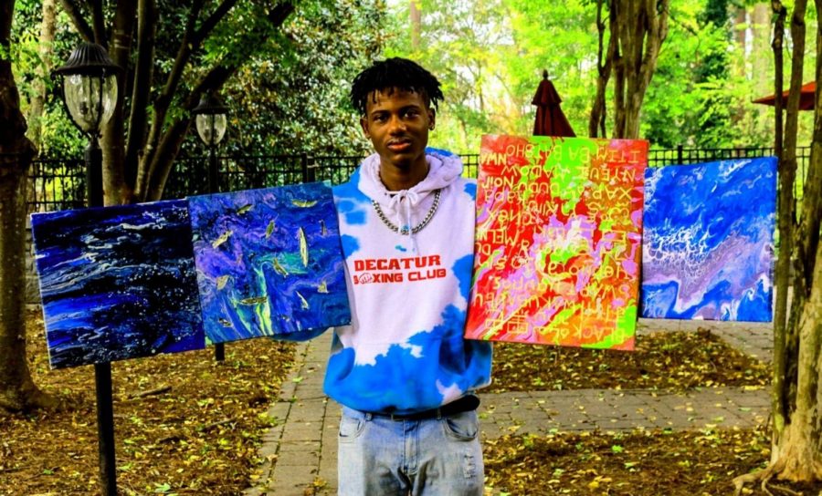 Emerging Artist: Like all other seniors, Jaylen Holt -- a member of the Marching Warriors -- has had to confront change. He’s using his senior year to develop his already very prodigious art skills. Here he holds his colorful and unique acrylic-pour canvases that are making splashes on social media platforms.