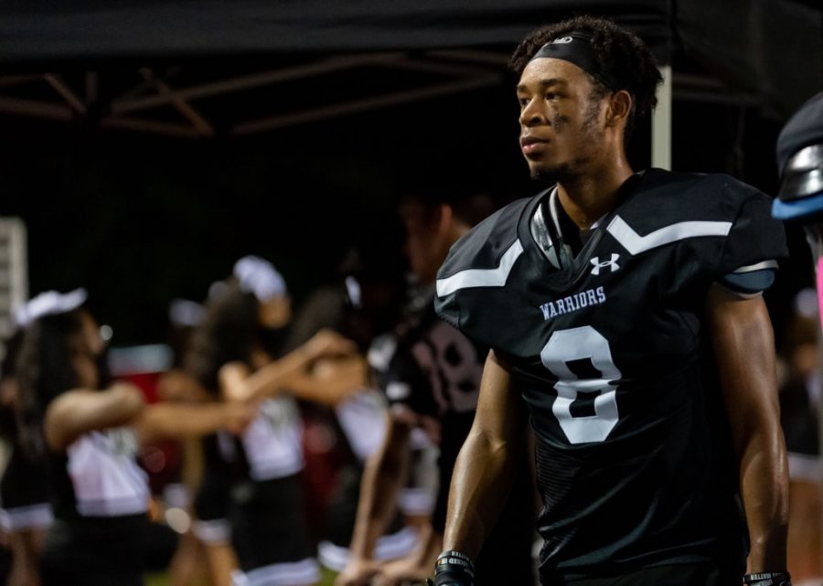 Sophomore wide receiver #8 DeShawn Merritt looks on.
