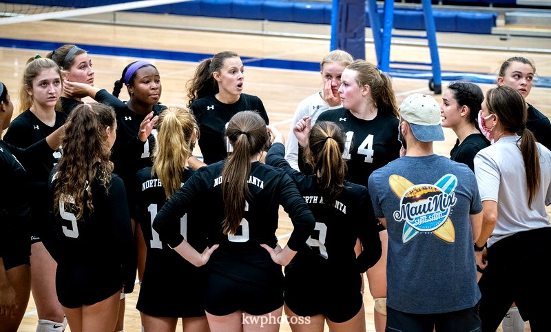 The Warriors volleyball team pulled in for a timeout to talk strategy for its last game of the season against Pope High School. The team fought hard in its efforts to win the match and move forward to the Region 6A Final Four. 