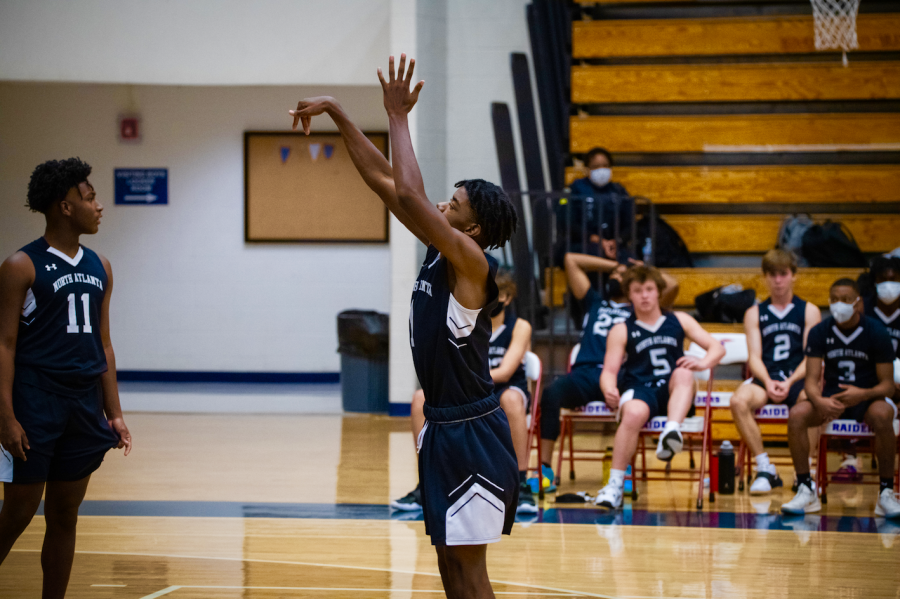 Junior Warrior T.J. Lewis (1) lets a free throw fly. 