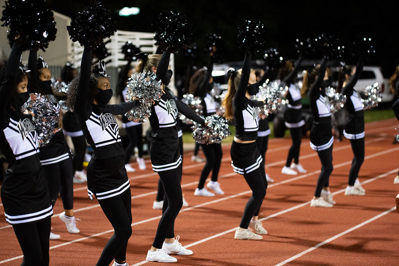 The Dubs wave their pom poms in celebration as the football team advances down the field at the October 16, 2020 game versus Tucker.