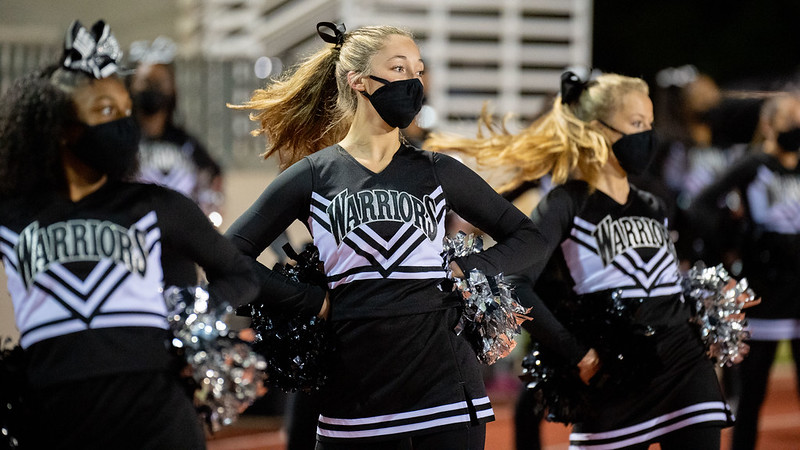 Varsity cheerleader seniors Amara Suarez, Reese Tobin and Marisa Humphreys spin toward the field as they lead things out during a cheer routine at the North Atlanta versus Tucker game on Oct. 16.
