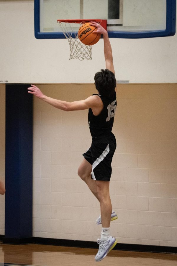 North Atlanta senior Charlie Hamilton (15) throws down a dunk.