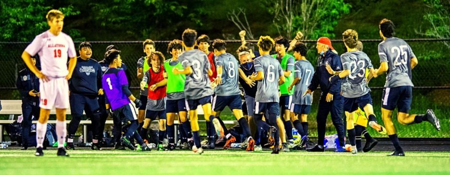 Sideline Euphoria: Dubs striker Jordan Chavez -- mobbed by his teammates -- strafes the North Atlanta sideline after scoring the winning overtime goal in the team’s 1 to 0 quarterfinals win over Allatoona on May 5. 
