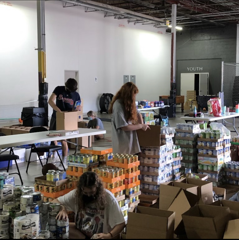 Lending a helping hand: Operation Feed has extended their organization to include NAHS students serving as ambassadors. These Dubs are hard at work helping APS families in need.