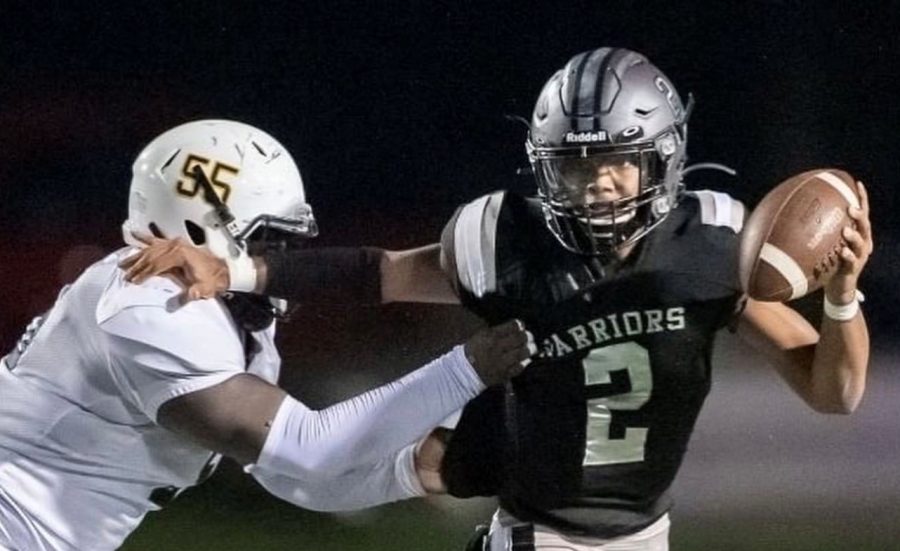 Dual Threat: Warrior quarterback Trey Lennon shows off his playmaking ability with a stiff-arm. He’s been at the heart of the team’s strong unbeaten showing early in the 2022 campaign. 
