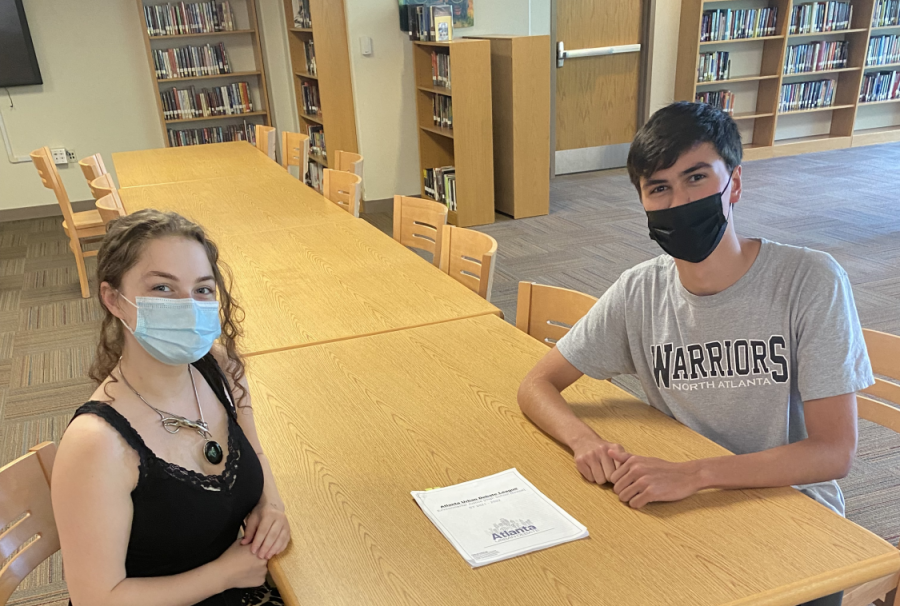 Proficient Public Speakers: Debate co-captain Curran Mitra coaches senior Mckenna Weinbaum, a competitor in preparation for the upcoming in-person policy debate. 