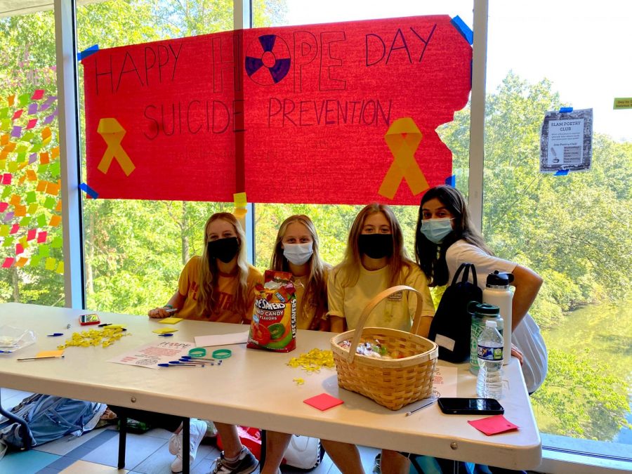 Here Comes the Hope: Katie Conner (10), Maggie Andreski (10), Lindsay Vicens (11), and Maggie Koontz (11) distribute Lifesavers candies and yellow ribbons to spread positivity on North Atlantas first Hope Day organized by Hope Squad.