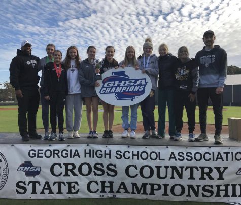The NAHS Cross Country girls celebrate a victorious 6A State title for the first time in 21 years