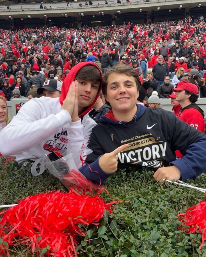 Dubs n Dawgs: Juniors John Gregory and
James O’Byrne among other Warriors migrate from Northside Pwky. to Athens to show their support for the Dawgs following UGAs win in the 2021-22 National Championships. 