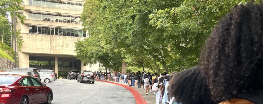 Welcome back: The security line to enter NAHS winds down the street as students wait to get their backpack checked.