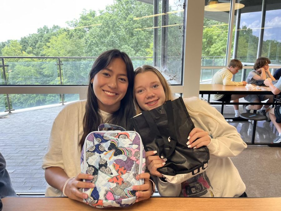 Forks Up: Sophomores Reagan Lerner and Carolyn Jahn flash a smile, ready to dig into their freshly-made lunches of the day! Lets explore the diversity of NAHS cuisine with an inside look into lunch culture inside of the eleven stories.