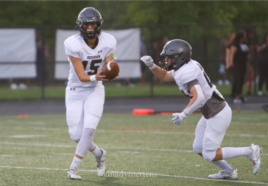 Backfield Bros: Quarterback Ian Reynolds hands the ball off to the power back Hunter Davis.