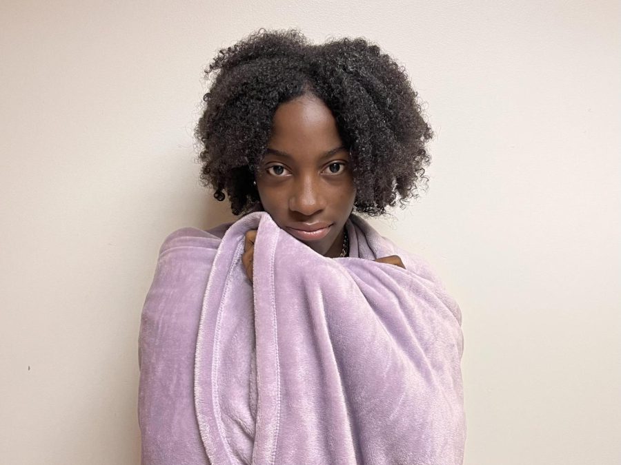 Bundle Up: Junior Emoni Hall wraps up with a fuzzy blanket to battle the tundra-like climate of North Atlanta.