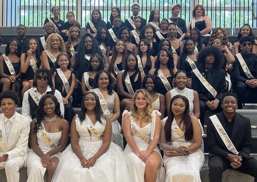 Sitting Pretty (and Handsome): As the pep rally roars on, the complete lineup of royal court candidates pose for a formal picture before the results are announced.